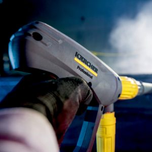 Person's hand holding Karcher EASY!Force trigger gun showing EASY!Lock functionality and Servo Control pressure adjuster.